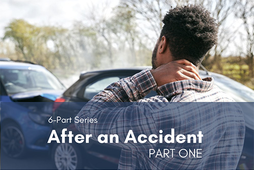 Driver rubbing the back of his neck while assessing a fender bender after a car accident