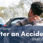 Driver rubbing the back of his neck while assessing a fender bender after a car accident